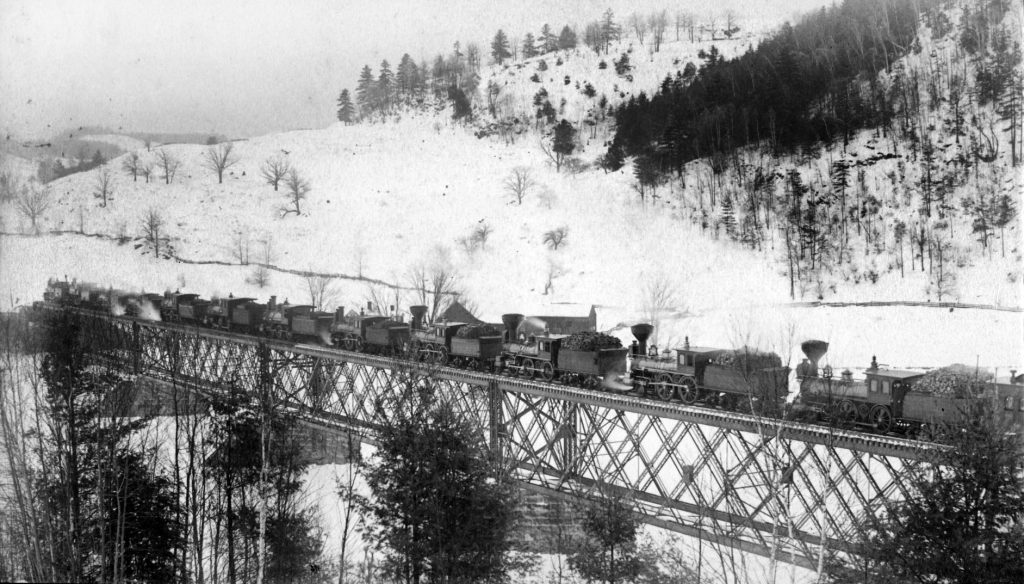 Locomotives testing the strength of the new bridge across the White River after the train wreck of 1887.